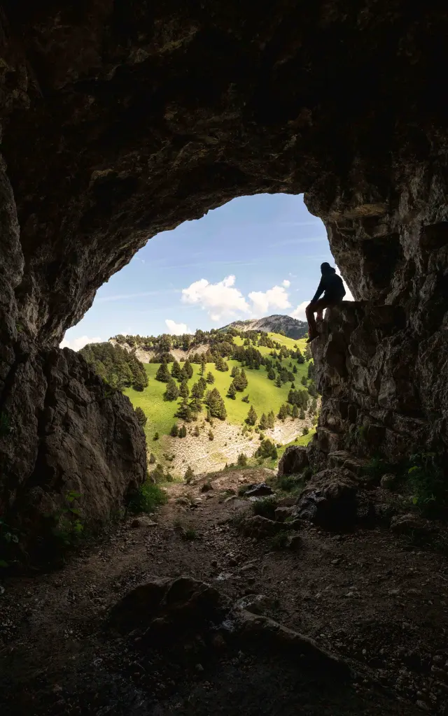 Natural U-shaped rock arch in a dense forest