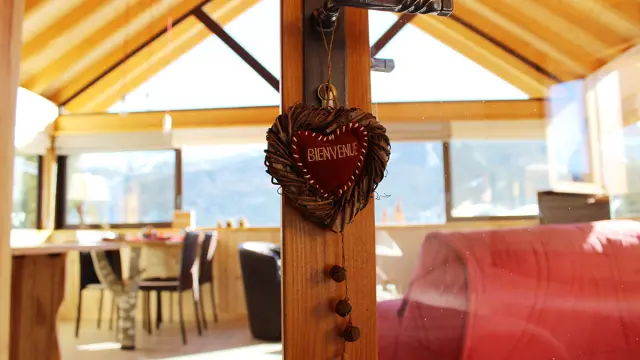 Wooden hanging sign indicating WELCOME with carved letters