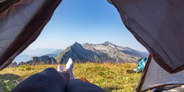 Open camping tent with a view of mountains in the background
