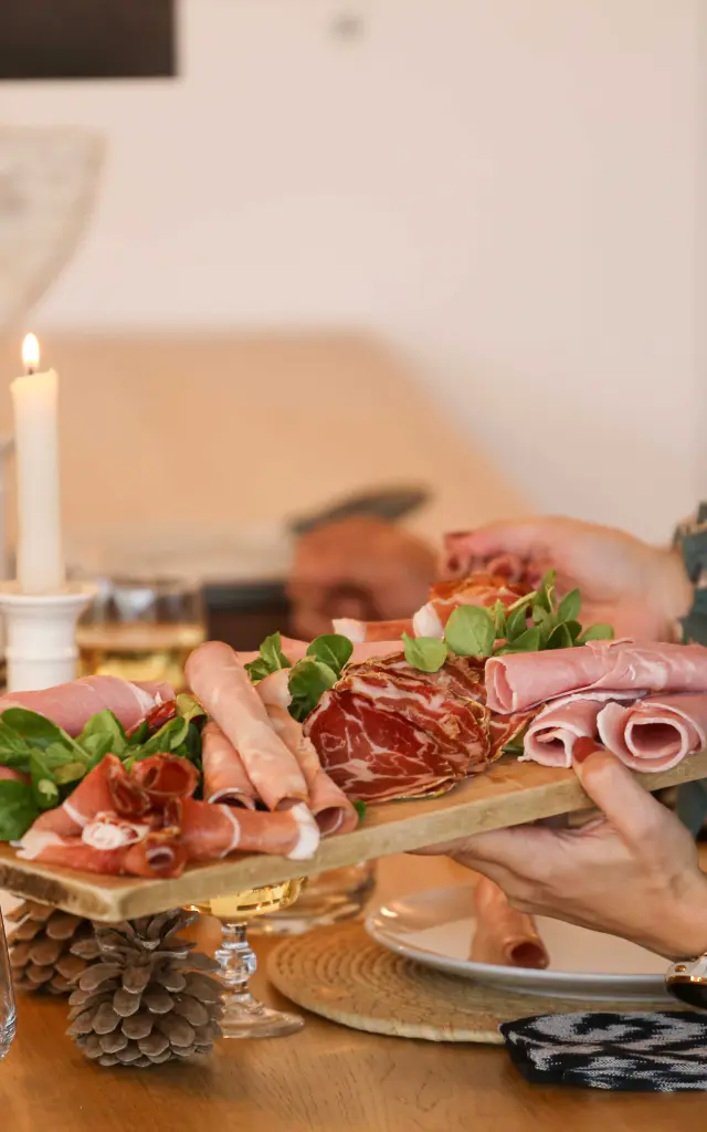 Terrasse de restaurant en soirée avec plats, boissons et convives