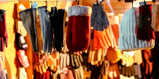 Shelves filled with hanging and stacked clothes in a shop