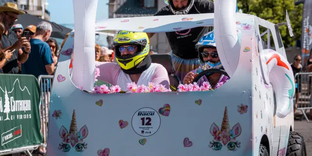Floats decorated with flowers and colorful patterns during a parade