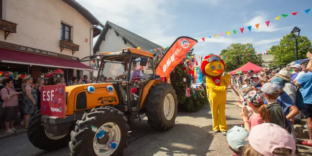 Manège vintage rouge et jaune avec des enfants et des adultes dans une fête foraine